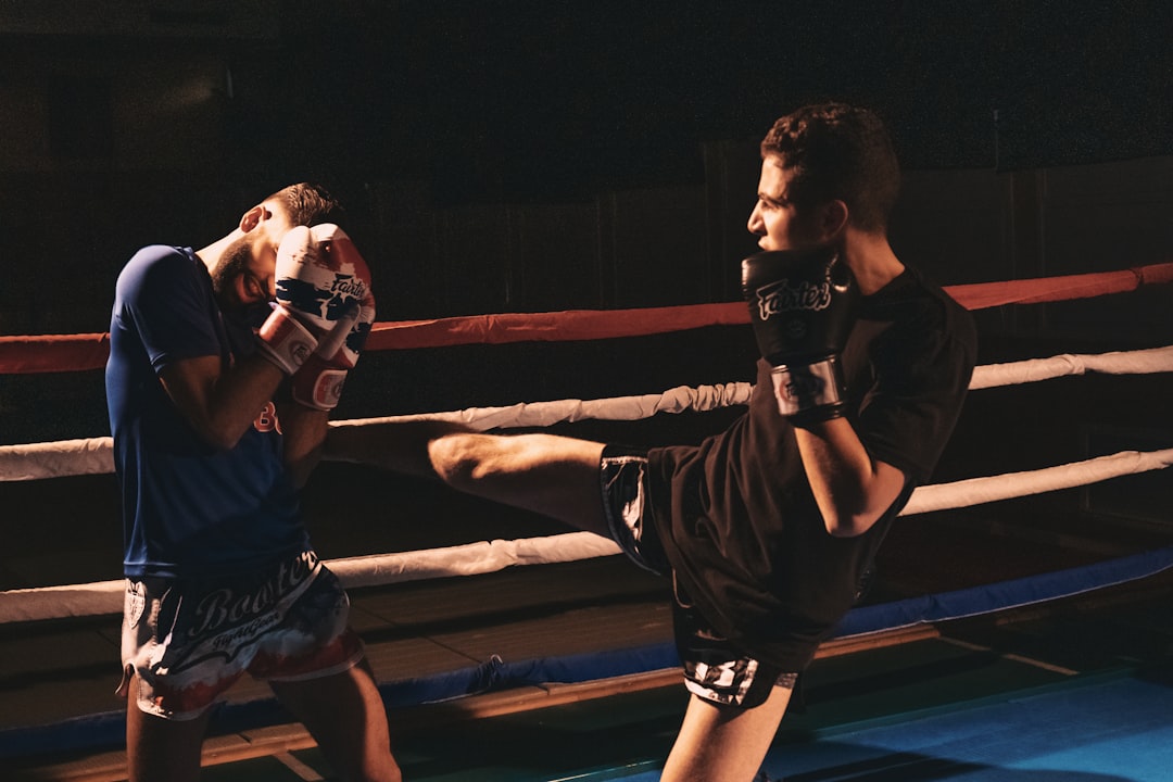 man in black nike jersey shirt and black shorts mma boxing, live stream, fight scene