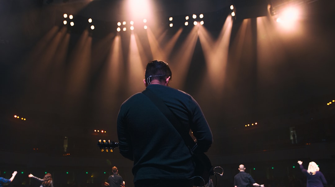 man playing guitar in concert lebron james, farewell, spotlight, nba fans