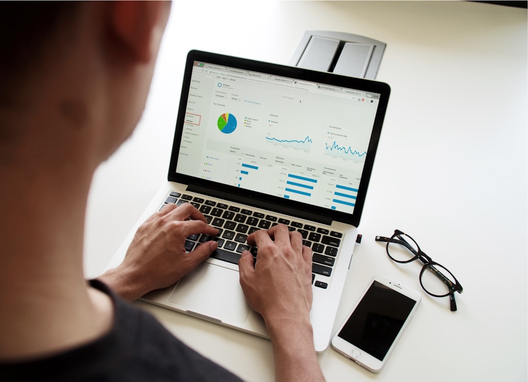 person using MacBook Pro real estate broker, crm mobile app, data analytics