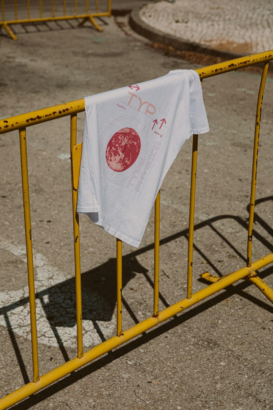 white and red textile on yellow metal fence heat press iron football shirt nameset