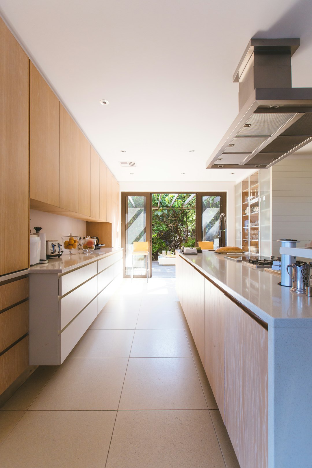 white wooden kitchen island and cupboard cabinets near glass panel door real estate paperwork, mobile screen, crm app