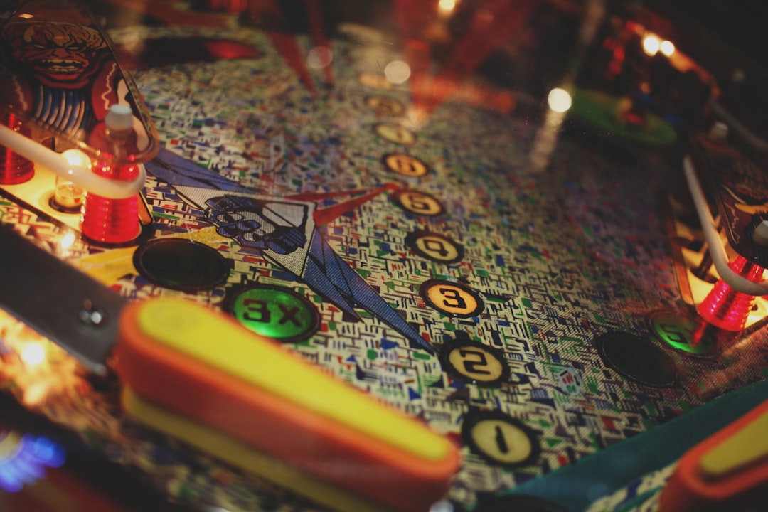 a close up of a pinball machine with a lit candle roulette table, european roulette, money chips