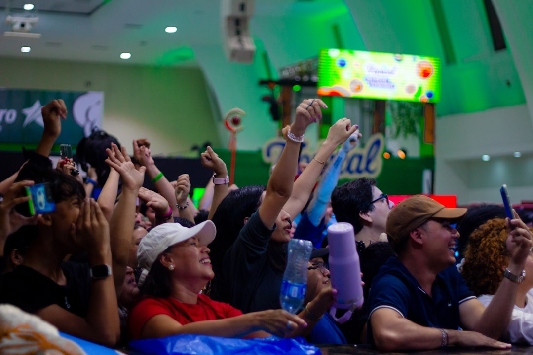 A crowd of people cheering at an event cheering tennis fans,uga bulldogs tennis,college tournament