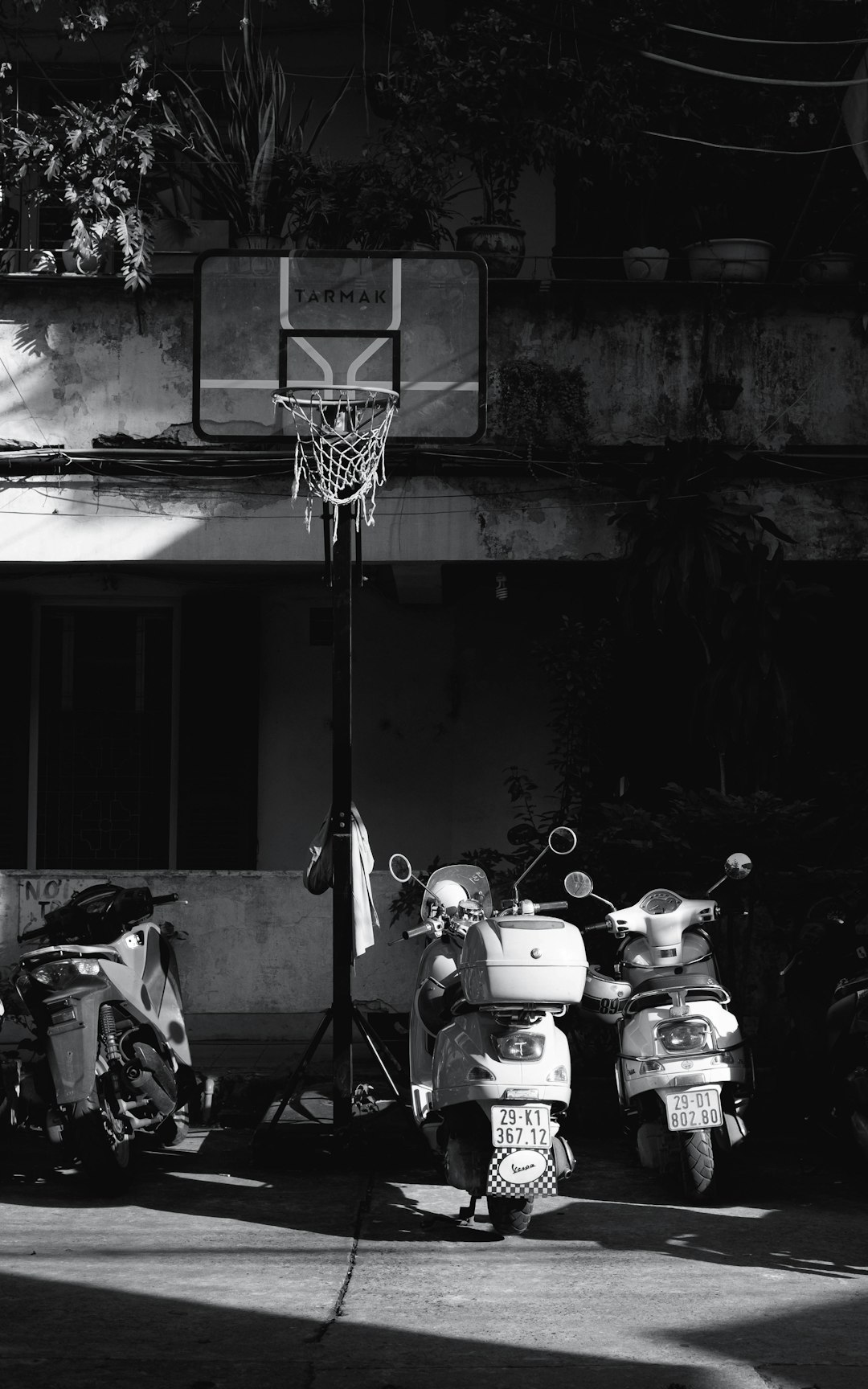 A group of motor scooters parked next to a basketball hoop basketball game team huddle