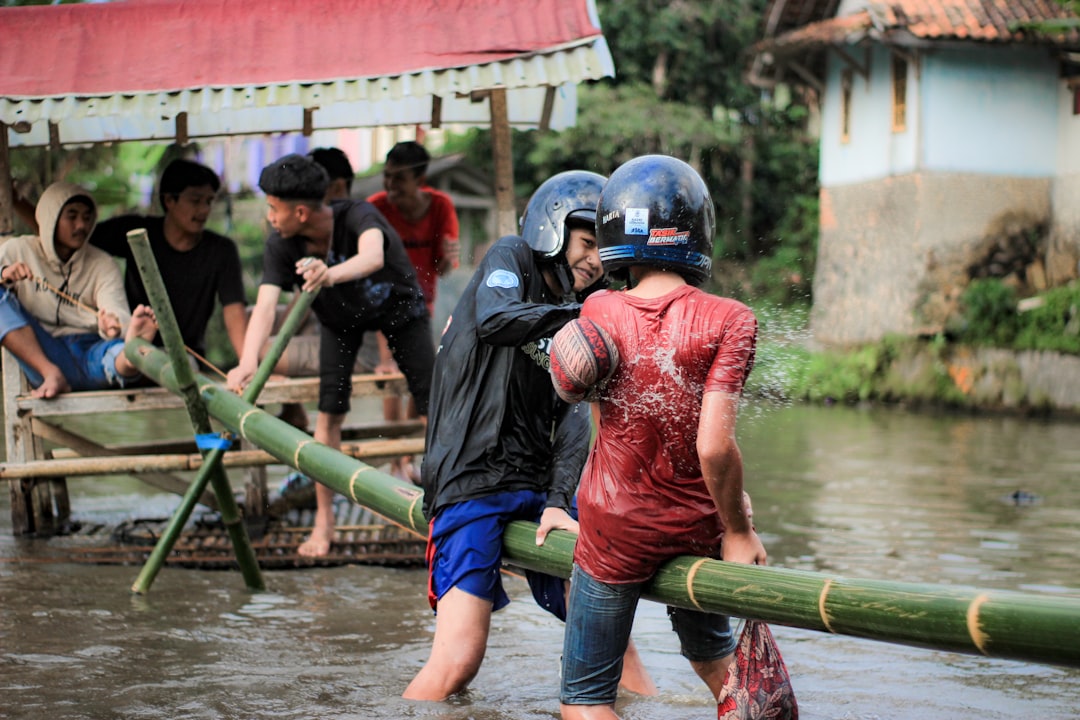a group of people in a flooded area football rain players mud