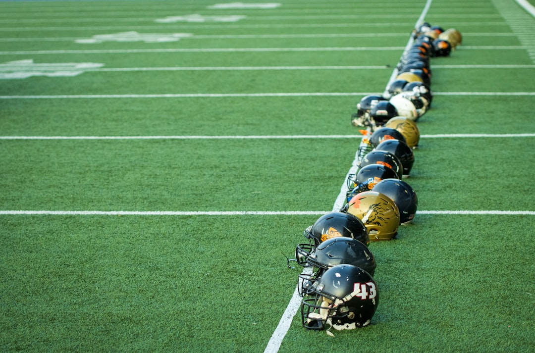 A line of football players lined up on the field nfl coach strategy, salary cap management, team planning