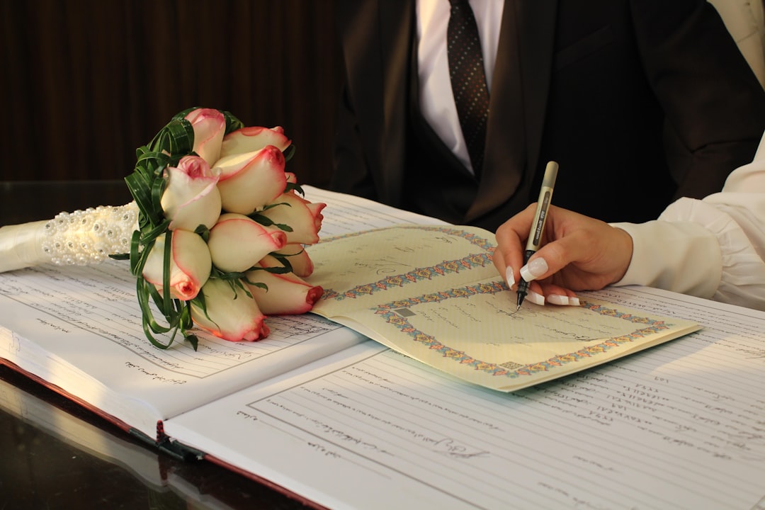 A man in a suit writing on a piece of paper football contract signing, nfl player agent, sports negotiation
