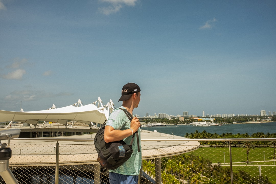 a man standing on a balcony overlooking a body of water miami dolphins, chad pennington, nfl comeback