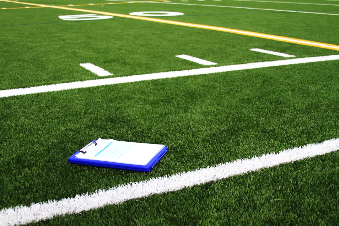 a notebook sitting on the side of a football field fantasy football draft