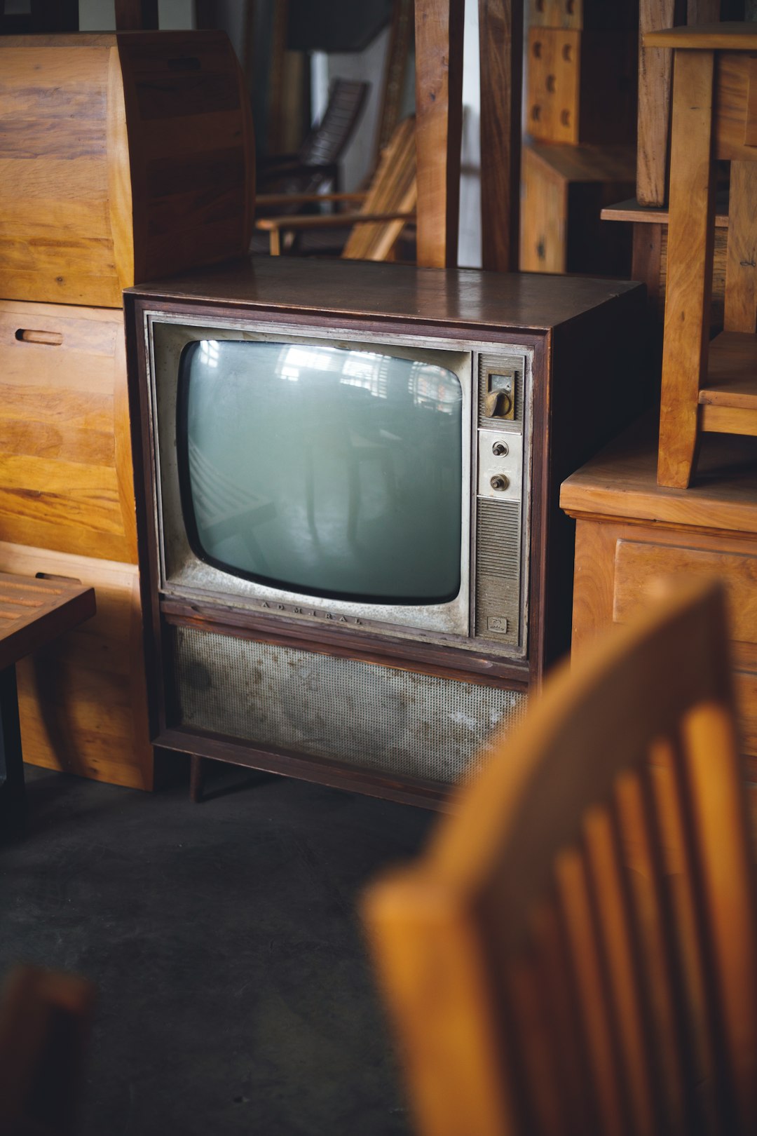 an old tv sitting on top of a wooden table vintage,football,television