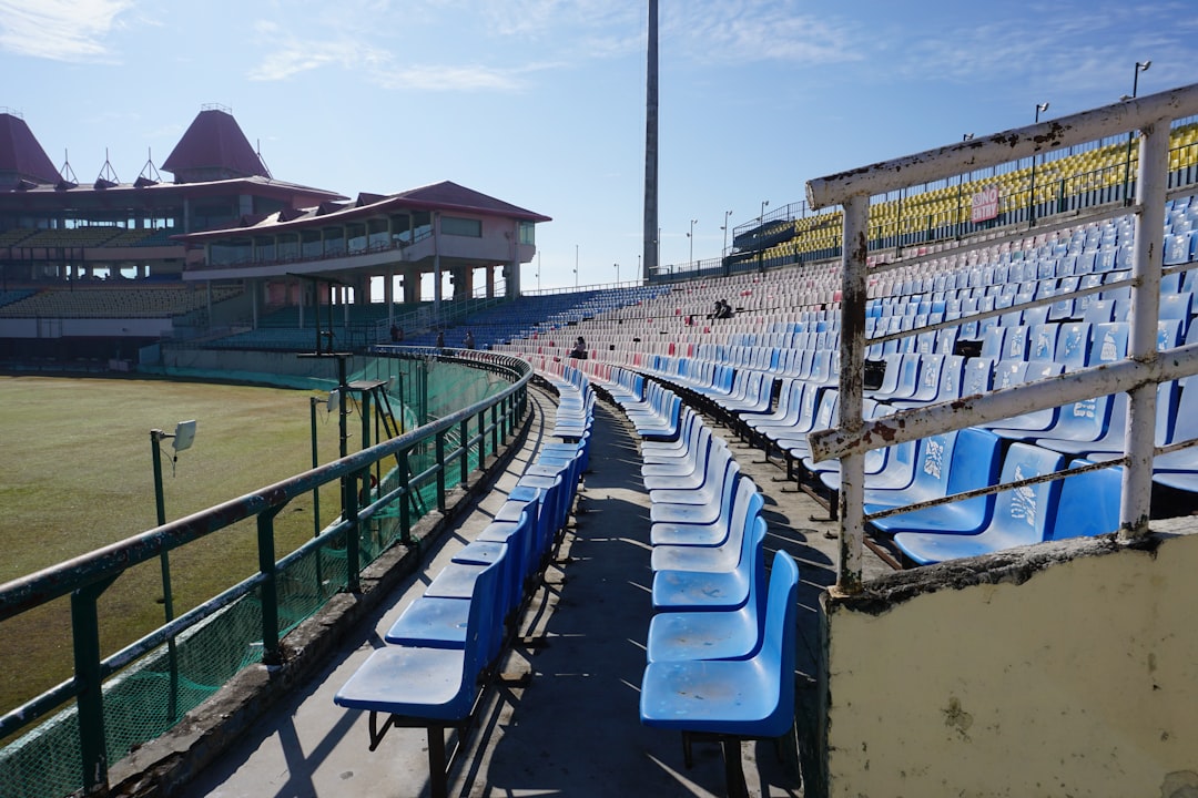 blue and white lounge chairs on green grass field during daytime virat kohli, kagiso rabada, one day international, cricket stadium