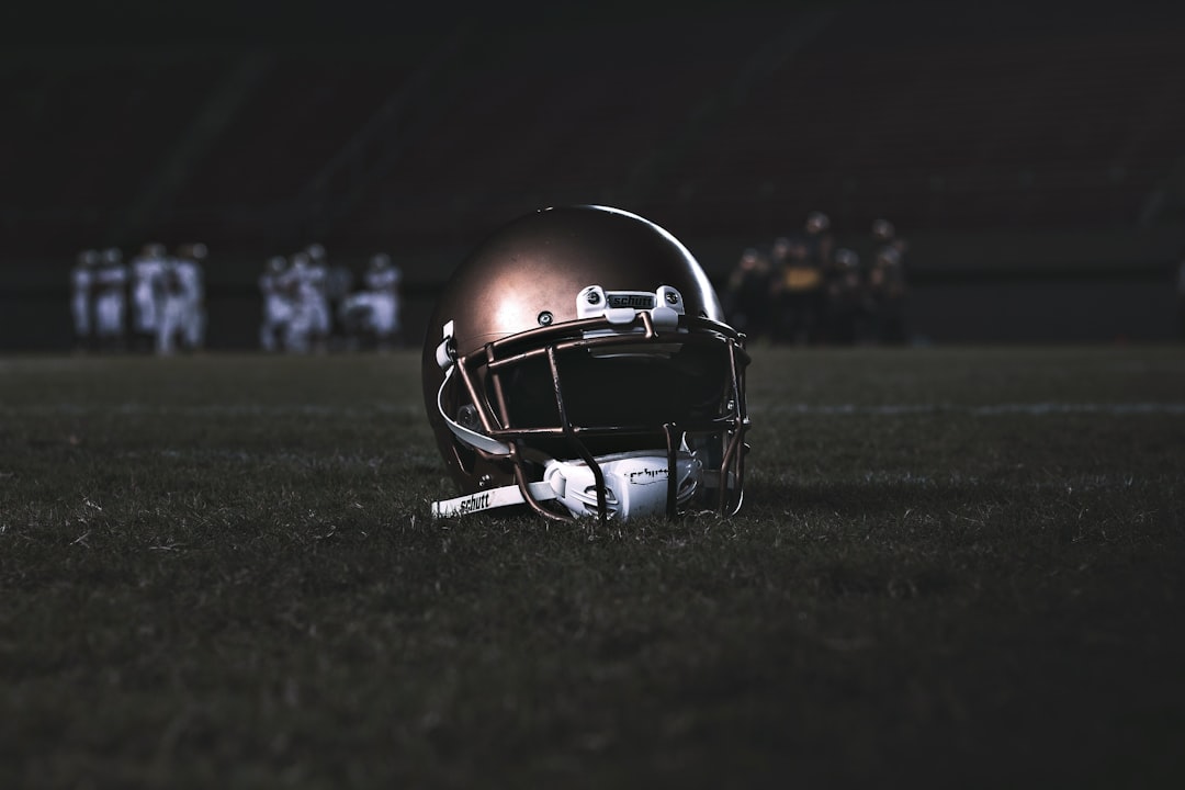 football helmet on green grass field during night time nfl rookies, fantasy football draft, fantasy sleepers