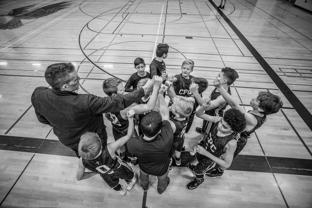 grayscale photography of boys raising hand team communication, sports parents, kids teams