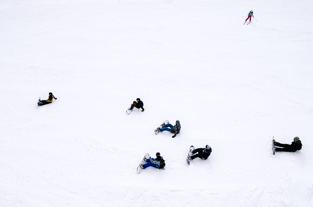 people playing snowboards snow football players bundled cold