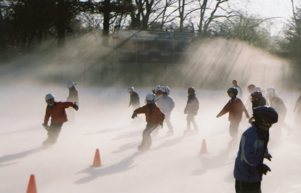 people walking on snow covered ground during daytime snow football players bundled cold