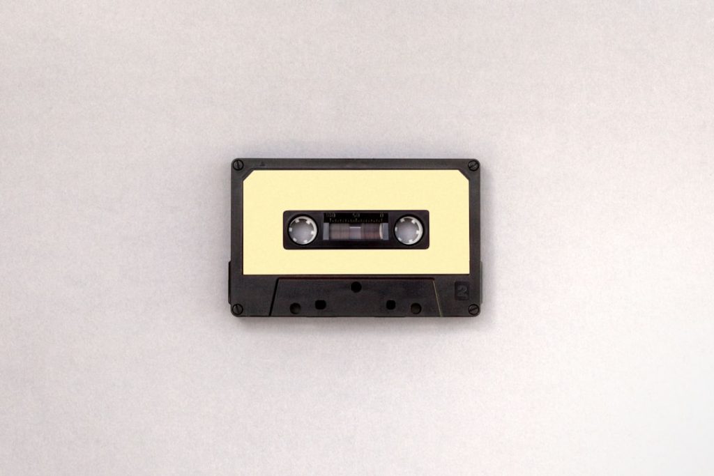 photo of black and brown cassette tape retro football gameplay, pixel graphics, colorful helmet