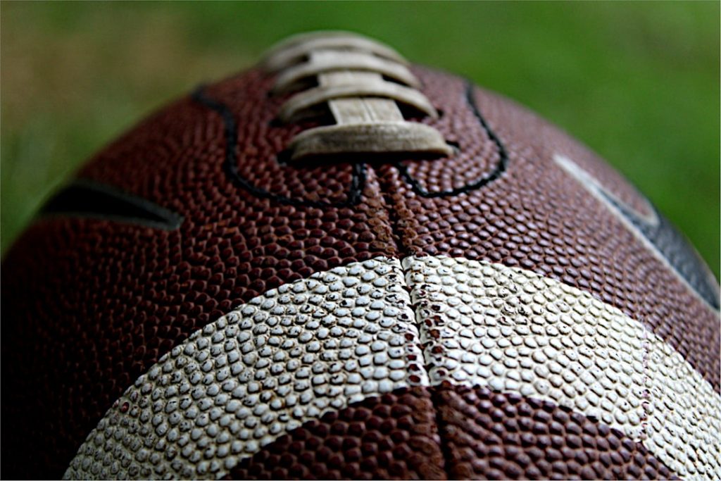 red and white football ball sports analysis, draft strategy, football team