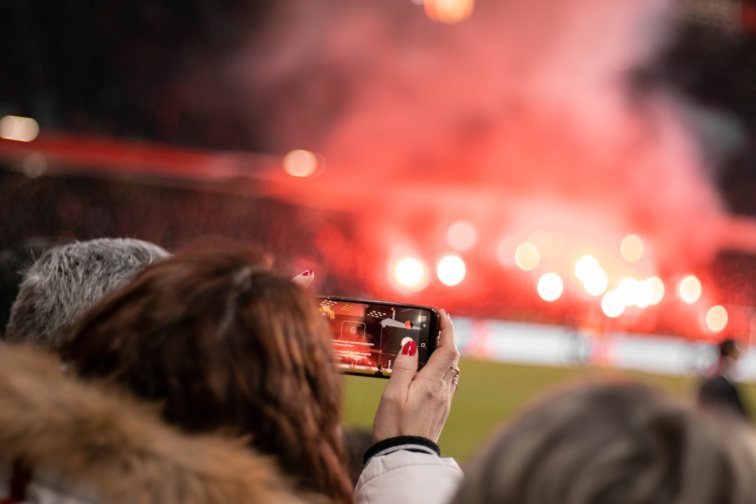 woman holding phone social,media,football