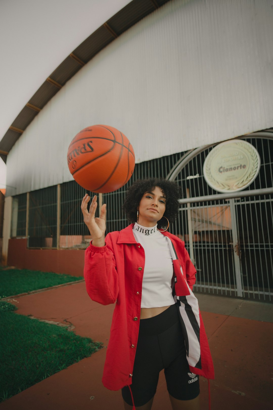 woman in red and white nike jersey holding basketball naia basketball player, tournament mvp, college of idaho hero