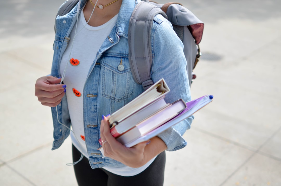 woman wearing blue denim jacket holding book college baseball, mlb the show 25, stadiums