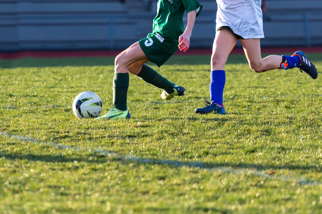 a couple of kids playing a game of soccer football green card player fair play