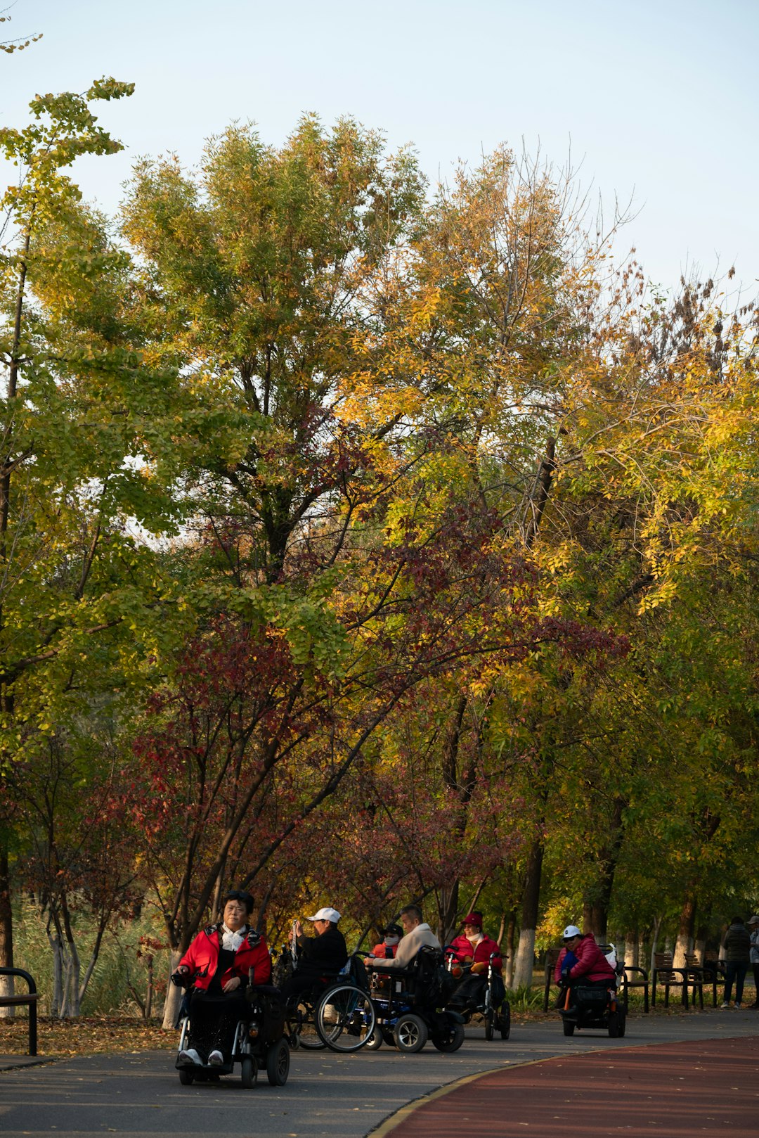 A group of people riding motorcycles down a street cross country team, runners trail, fall practice