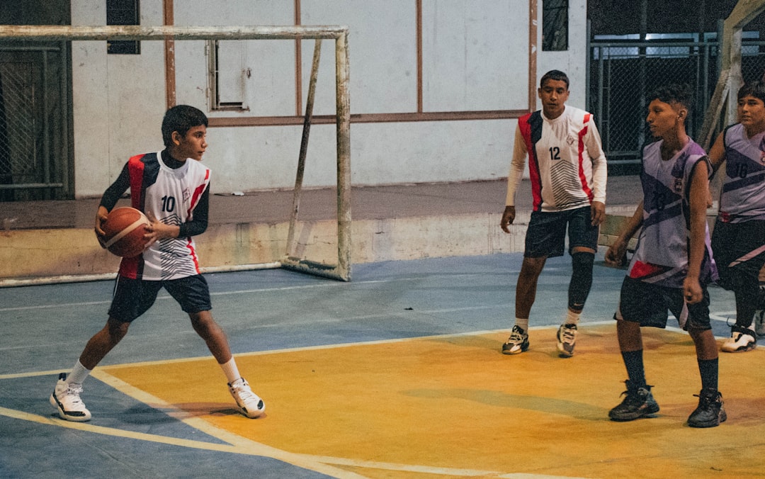 A group of young men playing a game of basketball football volley, player kicking ball mid air, football technique