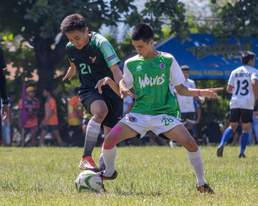 a group of young men playing a game of soccer football green card player fair play
