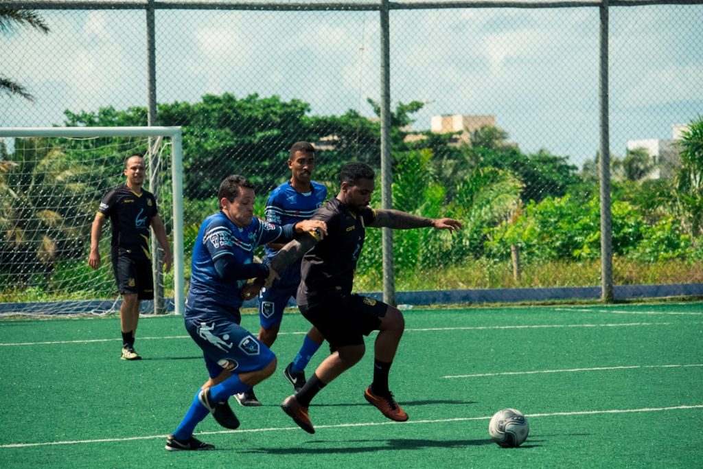 a group of young men playing a game of soccer professional soccer training, rondo, elite team