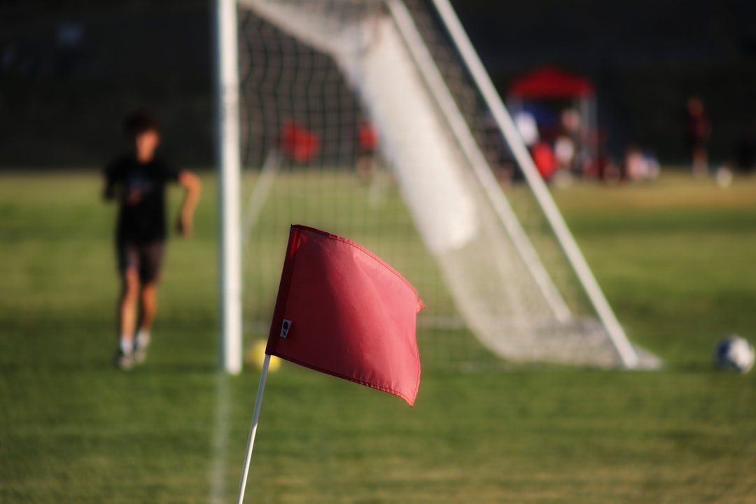 a red umbrella on a football field football red card referee match foul
