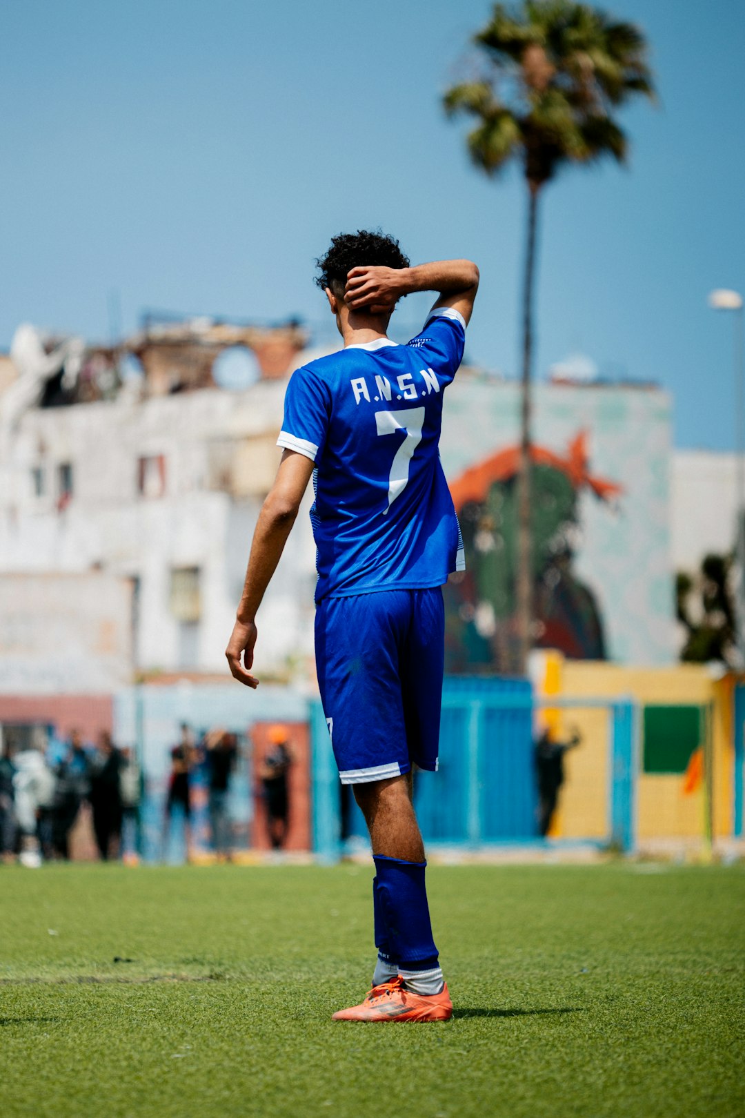 A soccer player stands on a field. antonio di natale, udinese striker, italian football
