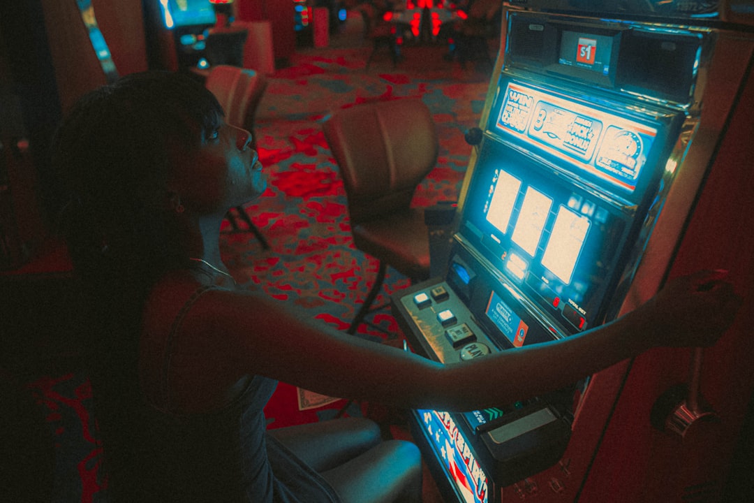 a woman playing a slot machine in a casino teenager at computer, risky behavior, gambling warning