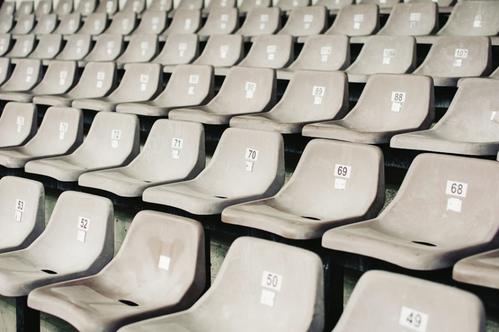 gray plastic benches english football stadium, matchday fans, league table