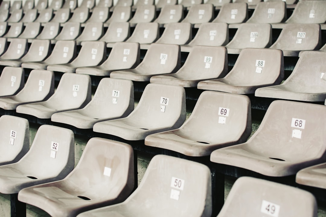 gray plastic benches english football stadium, matchday fans, league table