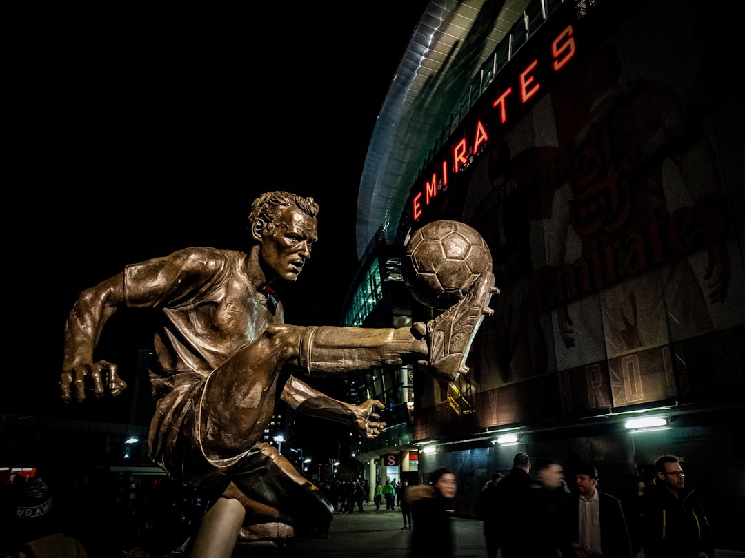 man playing soccer ball statue soccer legend, statue, legacy