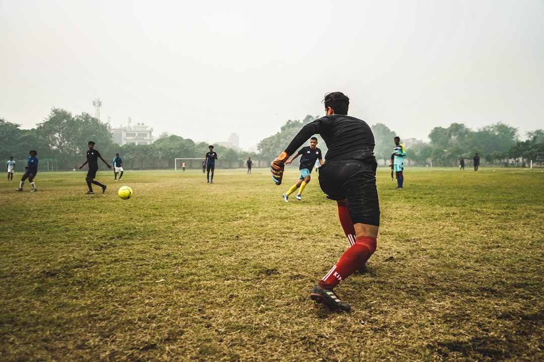 people playing soccer during daytime goalkeeper training, reflex drills, soccer goalkeeping practice