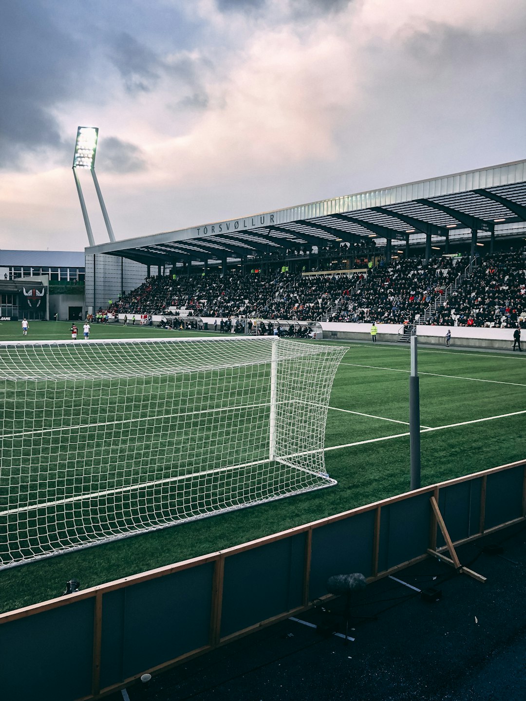 people watching soccer game under white and gray skies english football stadium, matchday fans, league table