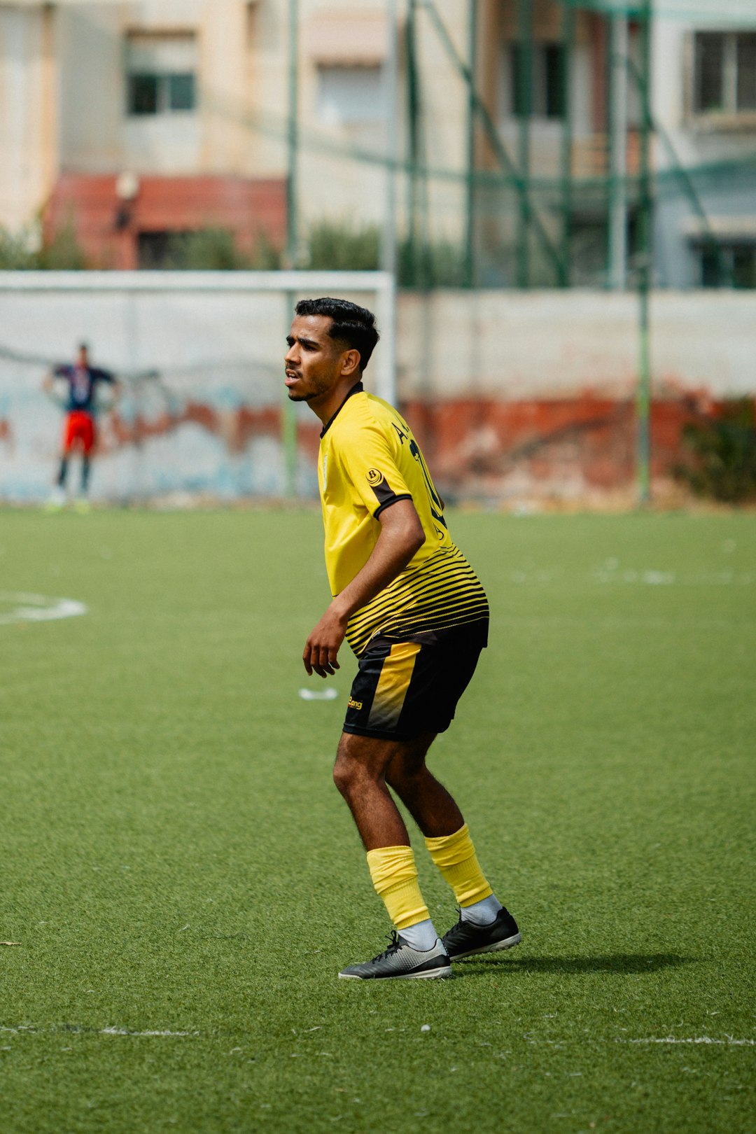 Soccer player in a yellow uniform on a field. claude makelele, defensive midfielder, football legend