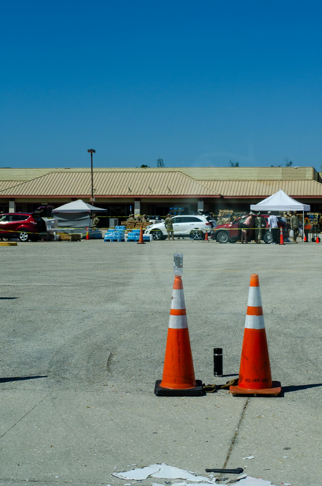 two orange and white cones sitting on top of an airport tarmac community event, local business, auto service booth