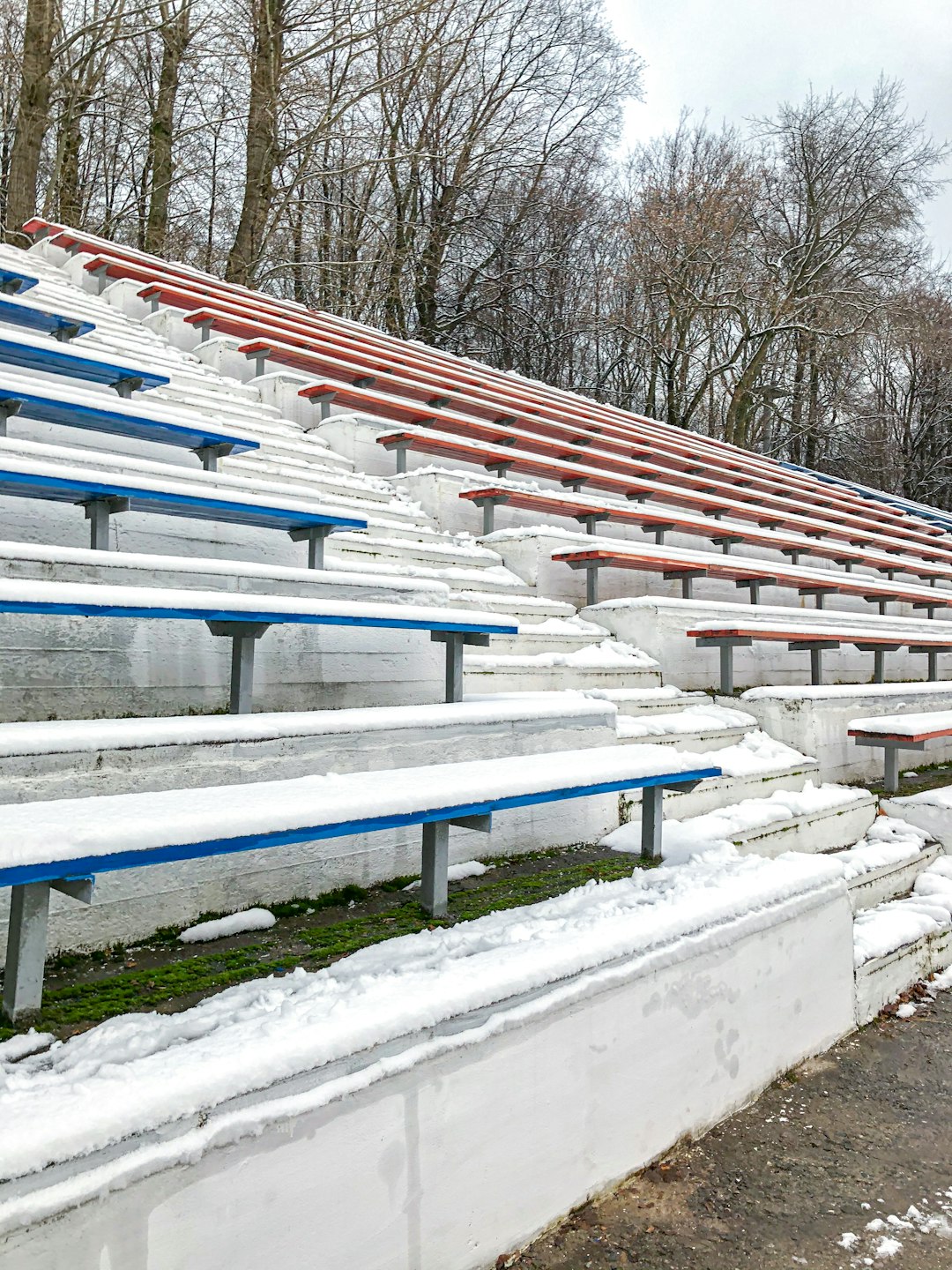 white and blue wooden fence covered with snow english football stadium, matchday fans, league table