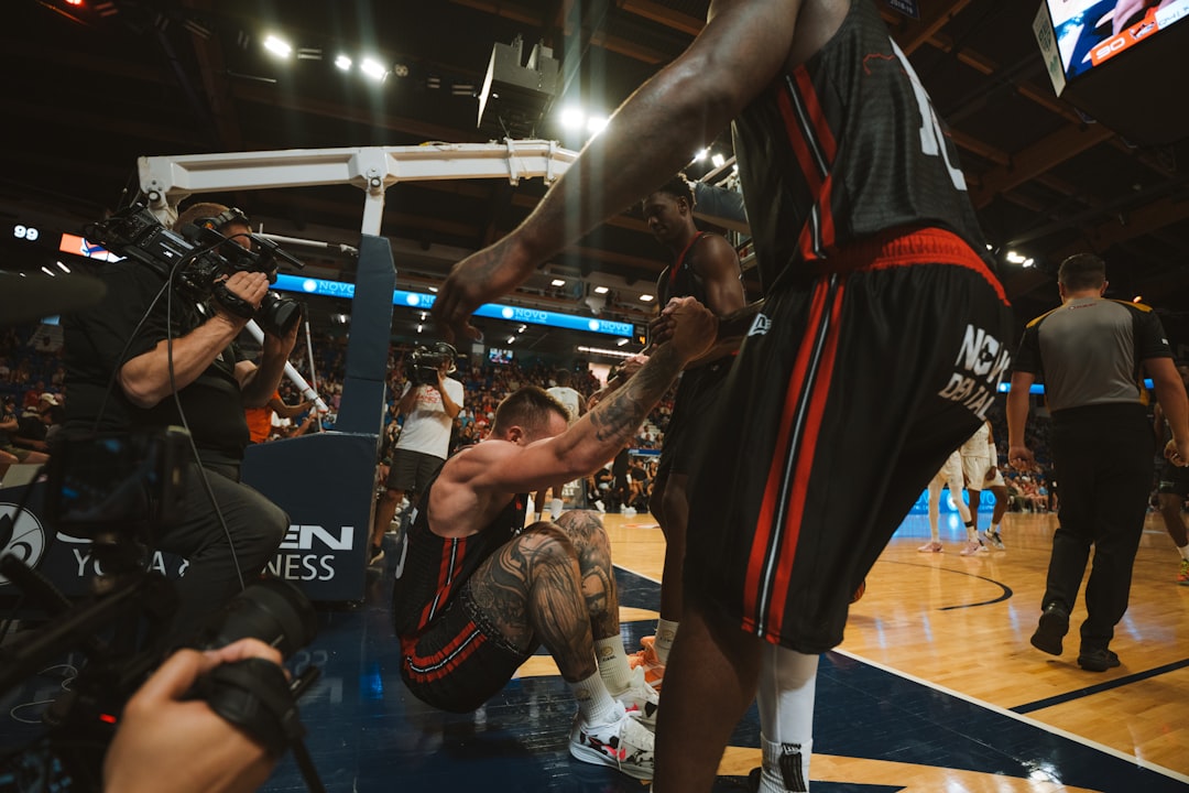 A basketball player being helped after a fall. viral basketball moment, fan reaction, nba highlight