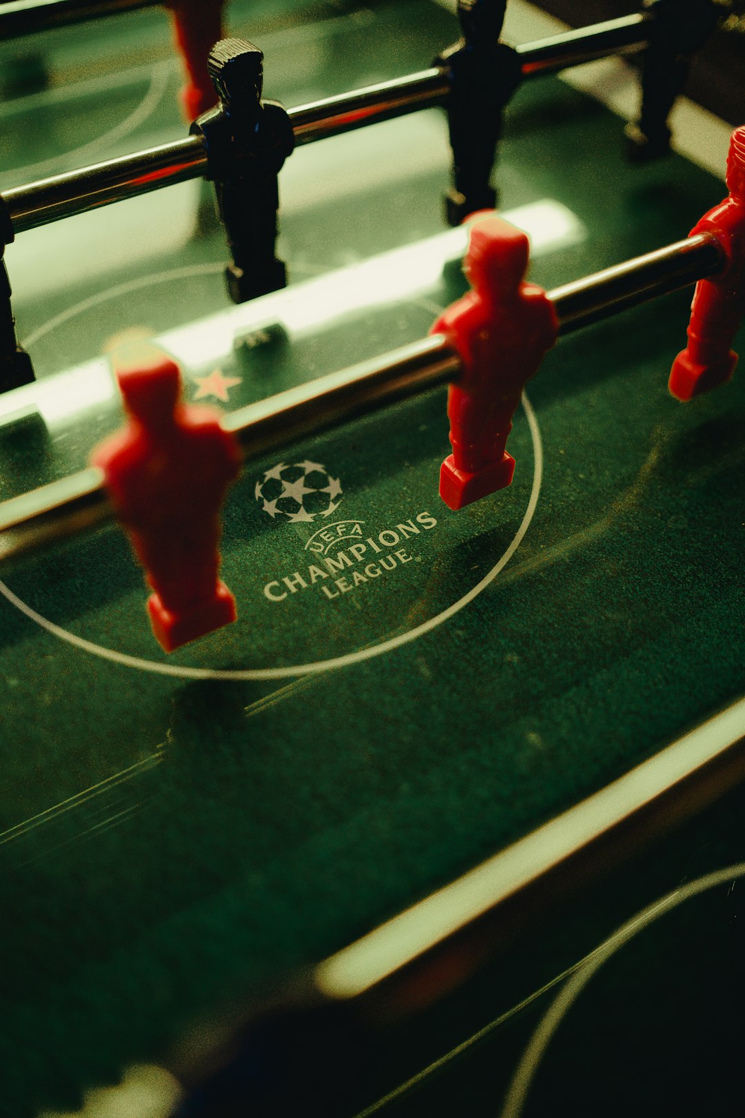 a close up of a foosball table with red foosball figures football parlay betting, sports betting strategy, betting slips