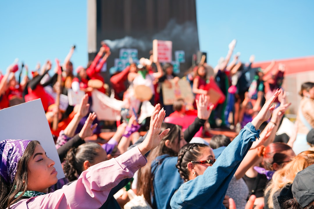 a crowd of people with their hands in the air fans holding signs, stadium engagement, crowd energy