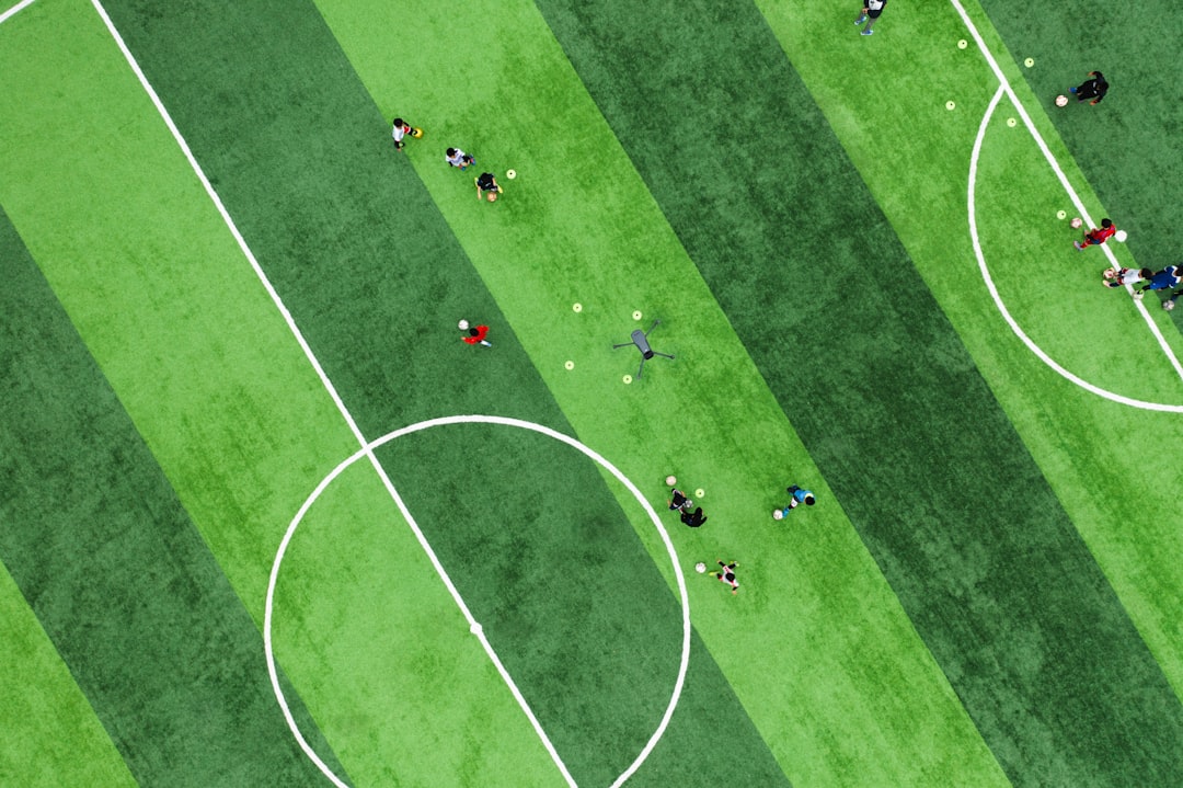 a group of people playing soccer on a field barcelona benfica tactics coach strategy