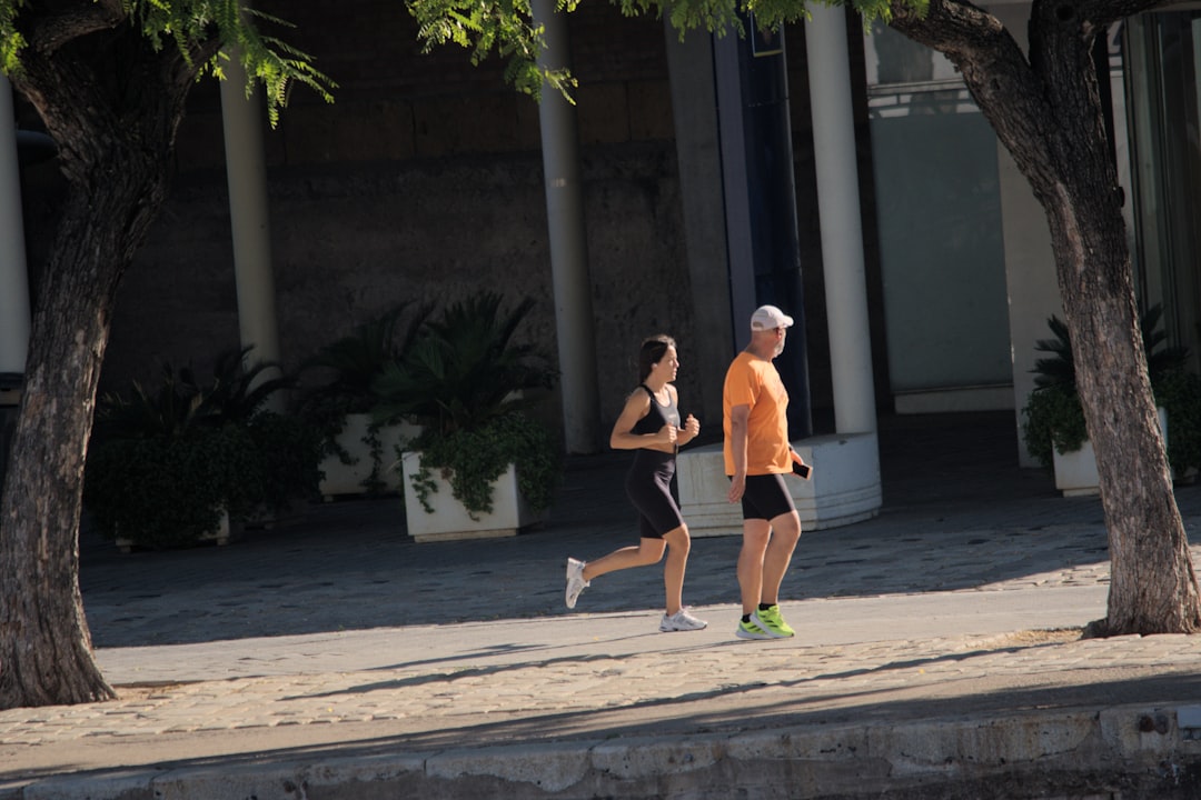 A man and a woman running down a street runner woman, ai coach, smart fitness tech