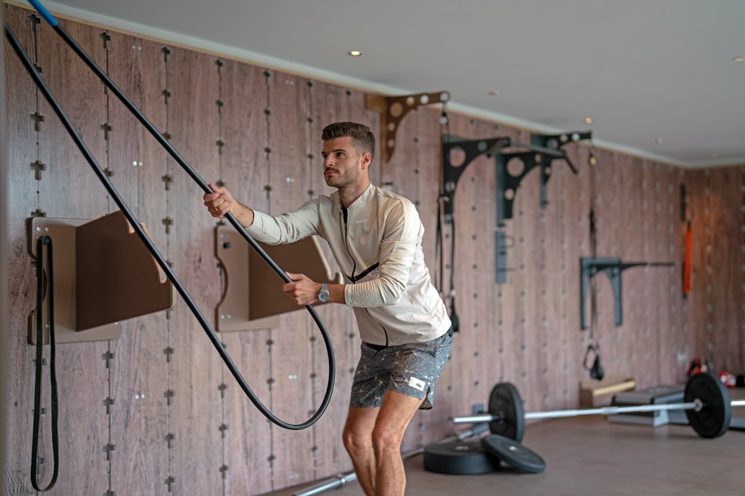 a man holding a gym rope in a gym gym workout weightlifting muscle