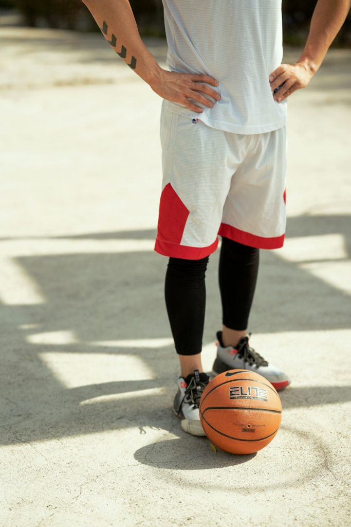 a person playing basketball high school basketball, happy crowd, teenager with jersey, gymnasium