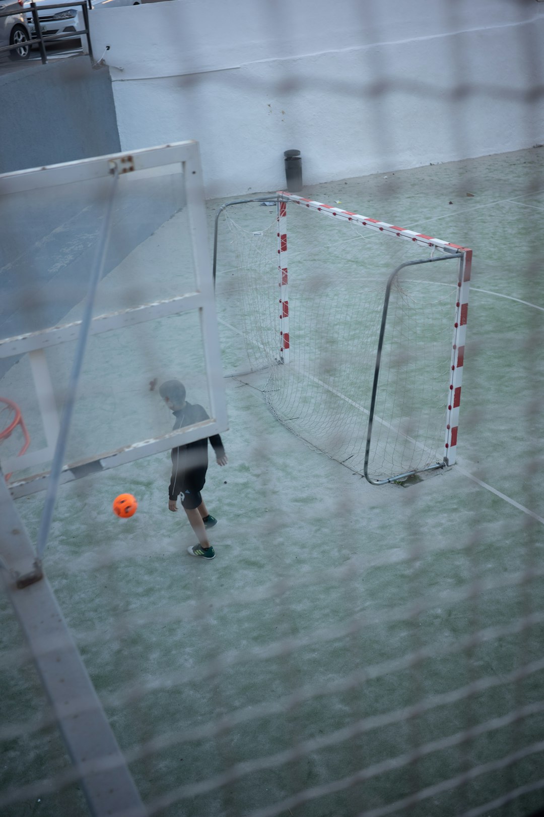a soccer goal with a soccer ball in front of it football injury, rainy game, unpredictable outcome