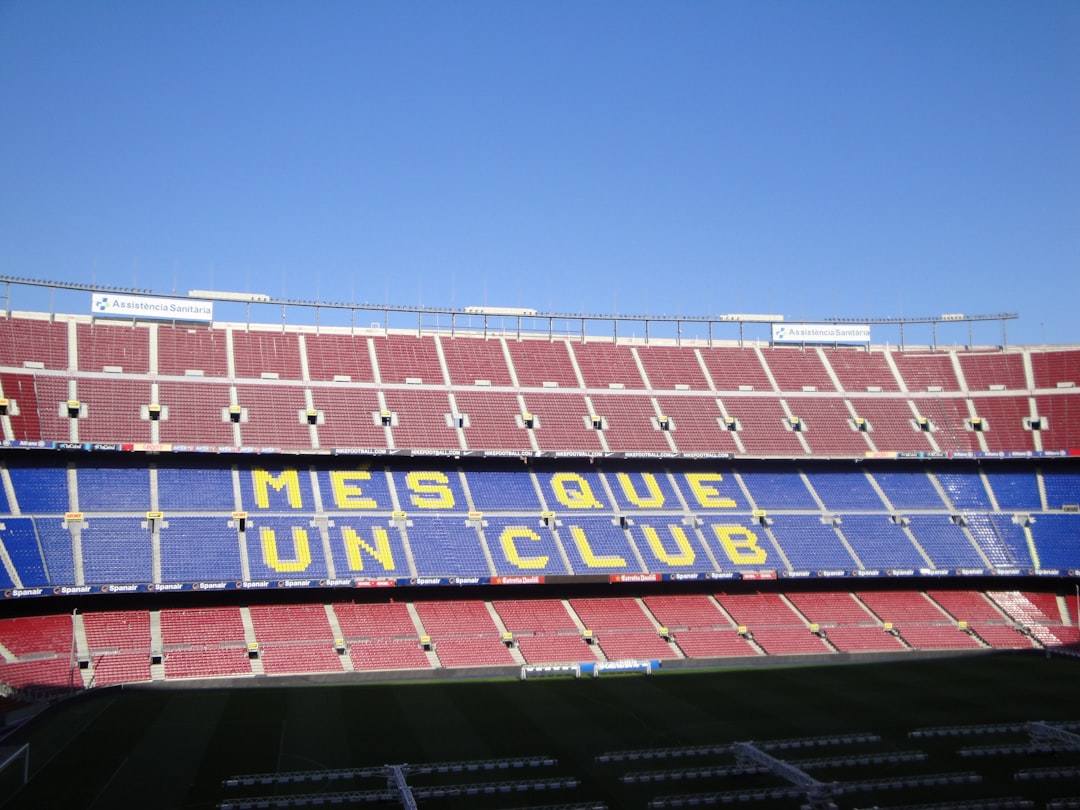 a stadium filled with lots of red and blue seats barcelona benfica tactics coach strategy