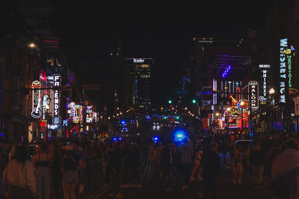 A vibrant, brightly lit city street at night. memphis grizzlies, nba party, nightlife